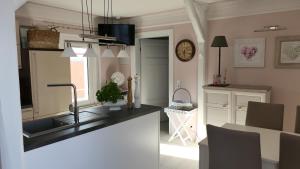 a kitchen with a sink and a counter top at Über den Dächern in Blankenburg