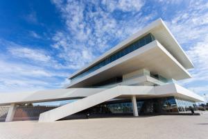 a large white building with a sky in the background at Big Terrace Apartment Cullera in Cullera