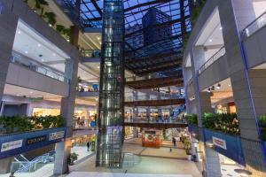 a shopping mall with a tall glass column in the middle at Big Terrace Apartment Cullera in Cullera