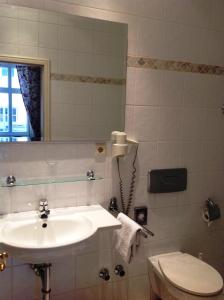 ein Bad mit einem Waschbecken und einem WC in der Unterkunft Hotel Adler in Rudolstadt