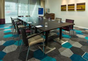 a conference room with a long table and chairs at Holiday Inn Express Lincoln City Centre by IHG in Lincoln