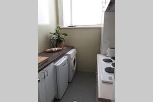 a kitchen with a sink and a stove top oven at Gawler Heritage Accommodation in Gawler