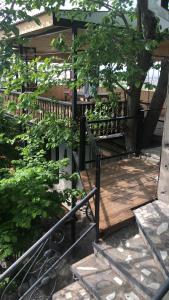 a wooden deck with a fence and a tree at Master's House Dayan in Yerevan