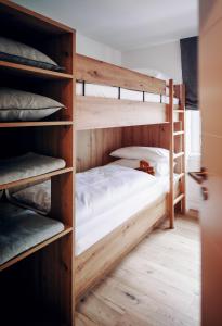 a bedroom with two bunk beds in a room at Walser ART in Mittelberg