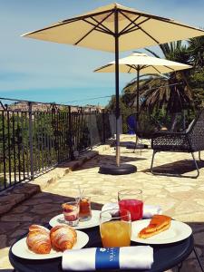 a table with two plates of food and drinks at Hotel Villa Flora Relais in Caltanissetta