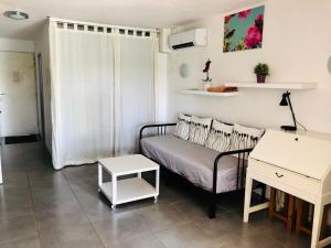 a small living room with a couch and a table at Appartement 239 Les Salicornes in Arles