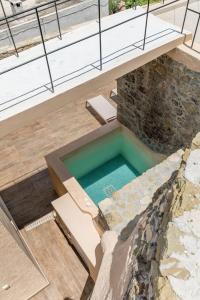 a swimming pool in the middle of a house at Pera Chorio - Daphne - Artist stone house with countryside views in Áyios Yeóryios