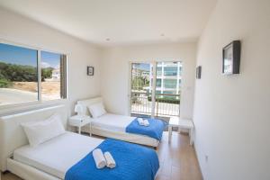 a room with two beds and a window at Delfini Villas in Protaras +125 photos
