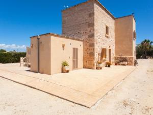 un gran edificio de ladrillo con un gran patio en Na frare casa de campo en Ses Salines