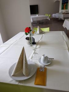 a white table with plates and utensils on it at Schloß Wittgenstein in Bad Laasphe