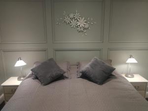 a bedroom with a large bed with two lamps at Haydn House in Glastonbury