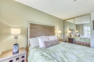 a bedroom with a bed and a large mirror at Plantation Hale in Kapaa