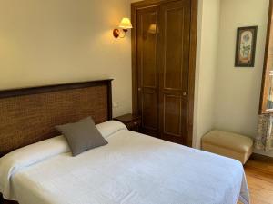 a bedroom with a bed with a pillow on it at Hotel Charle in Jaca