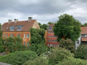 a group of buildings in a city with trees at ApartmentInCopenhagen Apartment 308 in Copenhagen