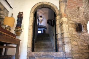 a stairway in a building with a stone wall and stairs at Alloggio Castello di Loreto in Todi