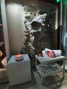 a room with a stone wall and a table with a cake at Scilla's Dream in Scilla +42 photos