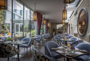 a restaurant with tables and chairs and windows at The Trinity City Hotel in Dublin