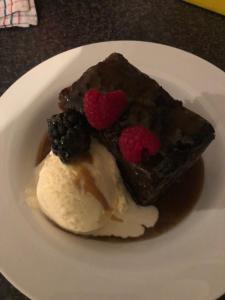 a piece of chocolate cake and ice cream on a plate at Riverview House Younghusband in Younghusband