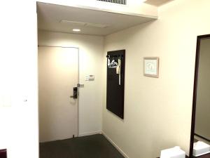 a bathroom with a toilet and a mirror at Asahi City Inn Hotel in Takaoka