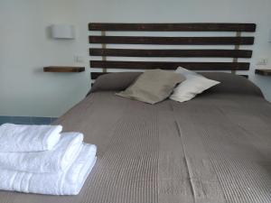 Un pat sau paturi într-o cameră la Judia Camere sul mare