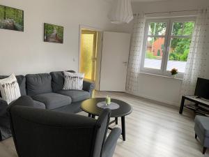 a living room with a couch and a table at Ferienhaus Fegebank in Nienhagen in Nienhagen