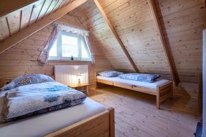 a bedroom with two beds in a log cabin at Arctic House in Dolný Kubín