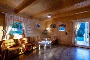 a living room with a couch and a table at Arctic House in Dolný Kubín