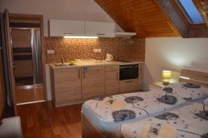 a kitchen with two twin beds in a room at penzion U Koníčka in Strážiště