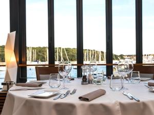 a table with wine glasses and napkins on it at Ribarska Koliba Resort in Pula
