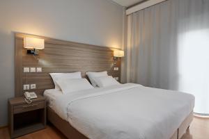 Ένα ή περισσότερα κρεβάτια σε δωμάτιο στο Ξενοδοχείο Βυζάντιο