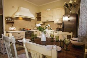 a kitchen with a table with chairs and a refrigerator at Sea front Almi in Vasiliki