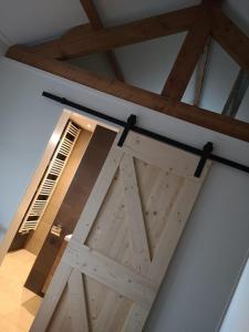 a barn door in a room with a window at Studio Zwin 9 in Zoutelande