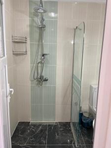 a bathroom with a shower with a glass door at Rose Hotel B&B in Patara