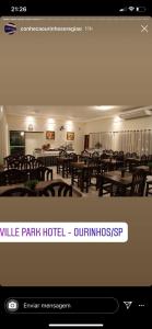 a picture of a restaurant with tables and chairs at Ville Park Hotel in Ourinhos