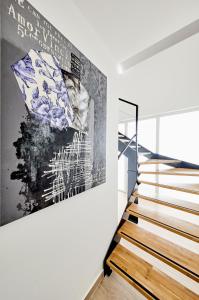 a staircase in a house with a painting on the wall at Ribarska Koliba Resort in Pula