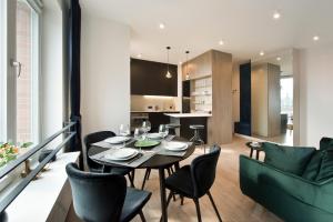 a dining room and kitchen with a table and chairs at YOURAPART Rajska City Centre in Gdańsk