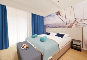 a bedroom with a bed with a bowl of fruit on a table at Ribarska Koliba Resort in Pula