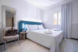 Postel nebo postele na pokoji v ubytování Hotel Grifo