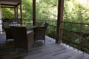 a screened in porch with a table and chairs at Apricot Aghveran Resort in Aghveran