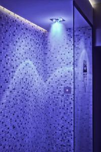 a bathroom with a tile wall with a heart on it at Hotel Touring Wellness & Beauty in Fiuggi