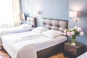 Posteľ alebo postele v izbe v ubytovaní Hotel Floryan Old Town