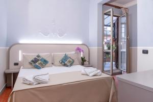 Postel nebo postele na pokoji v ubytování Hotel Grifo