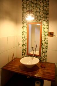 
a white sink sitting under a mirror in a bathroom at Villa Chic Hostel Pousada in Jericoacoara
