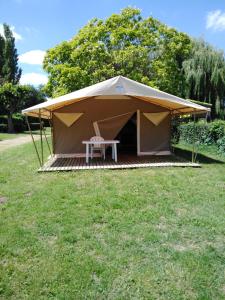 a tent with a picnic table in a field at Camping de Marcilly sur Vienne in Marcilly-sur-Vienne +9 photos