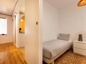 a small bedroom with a bed and a hallway at Lovely apartment Poble Sec II in Barcelona