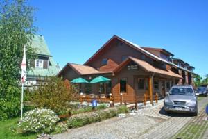a house with a car parked in front of it at Apart Hotel Villa Los Ciruelos in Valdivia
