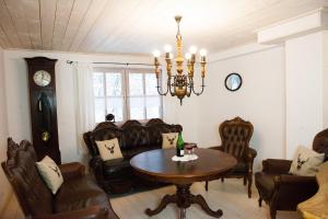 een eetkamer met een tafel, stoelen en een kroonluchter bij Kaffeehaus Blaslhöhe in Lam