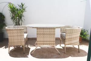 a rattan table and two wicker chairs around a table at Parco Augusto in Capri