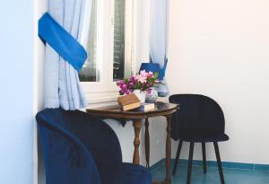 a room with a table and two chairs and a window at Parco Augusto in Capri +36 photos