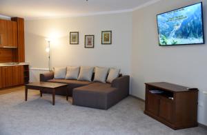 a living room with a couch and a flat screen tv at Villa Maria Revas in Sunny Beach